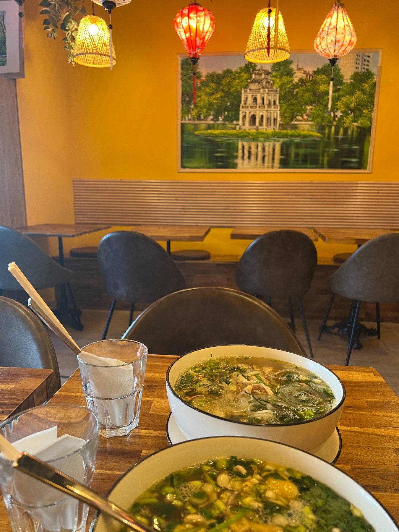 Two bowls of phở in the dining room at Phở Hà Nội Quán